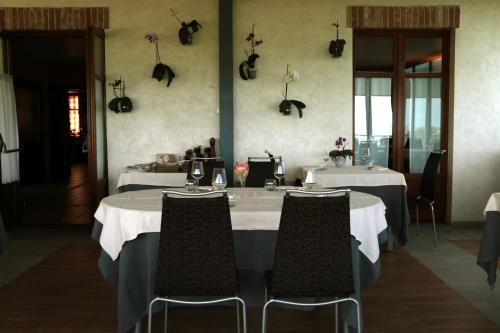 a dining room with two tables and two chairs at La rosa dei vini in Serralunga d'Alba