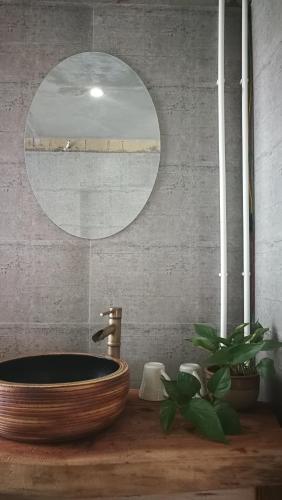 a bathroom with a wooden sink and a mirror at Green Hostel & Sunny Guesthouse in Yuanyang