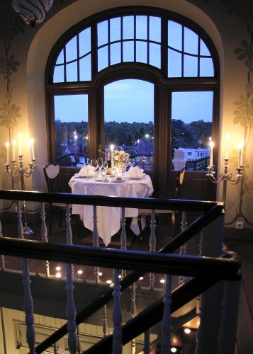 a table in a room with a window at Villa Ammende Restaurant and Hotel in Pärnu