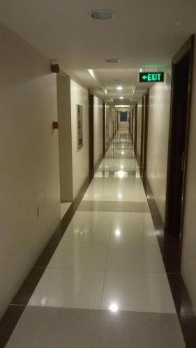 an empty hallway in a building with a sign on it at Nica's Place Property Management Services at Horizons 101 Condominium in Cebu City