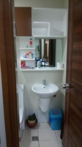 a bathroom with a sink and a toilet at Nica's Place Property Management Services at Horizons 101 Condominium in Cebu City