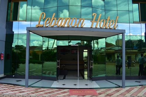 a glass building with a sign on top of it at Lebanon Hotel in Kigali