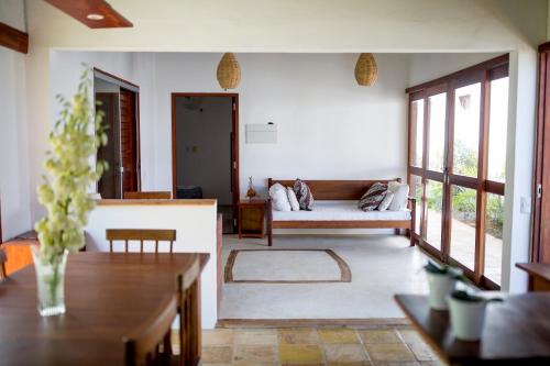 a living room with a couch and a table at Tropical House - Villa com piscina perto do mar in Jericoacoara