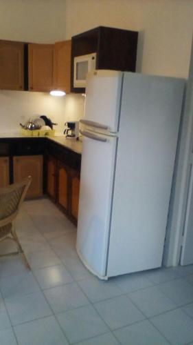 a kitchen with a white refrigerator in a kitchen at Seaclusion in Gros Islet
