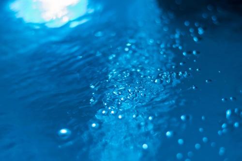 a close up of water bubbles in a pool at Uncle's Luxury Jacuzzi in Adamas