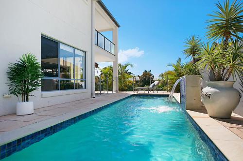 a swimming pool in front of a house at Escape to the Coast in Gold Coast
