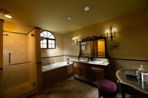 a bathroom with a tub and a sink and a bath tub at Casa del Mar Langkawi in Pantai Cenang