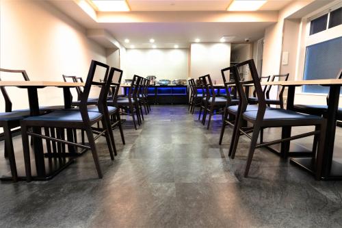 a row of tables and chairs in a room at Marutamachi Crystal Hotel in Kyoto