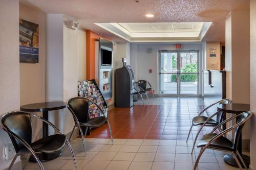 a waiting room at a hospital with chairs and tables at Motel 6-Irving, TX - DFW Airport North in Irving