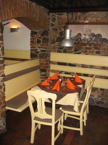 a dining room with a table and chairs and a piano at Guesthouse Stari Tišler in Ljubljana