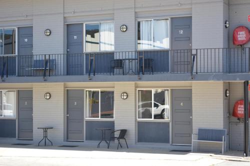a building with tables and chairs on a balcony at Commercial Hotel Motel Lithgow in Lithgow