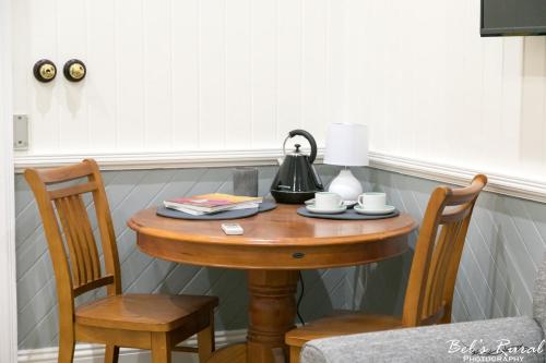 a small table with two chairs and a lamp on it at The Convent Boutique Accommodation in Hay