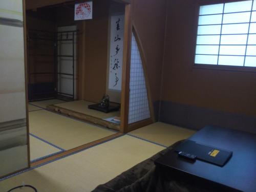 a room with a mirror in the corner of a room at Koyasan Shukubo Sainanin in Koyasan