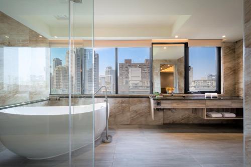 a bathroom with a tub and a large window at Sun Hao Hotel Taichung in Taichung