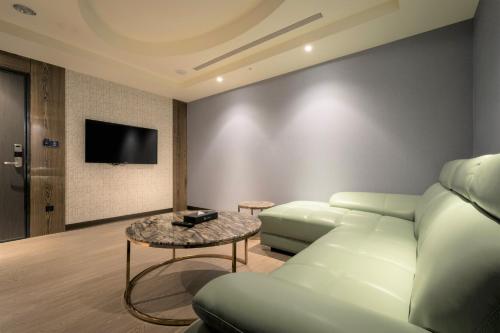 a living room with a couch and a table at Sun Hao Hotel Taichung in Taichung