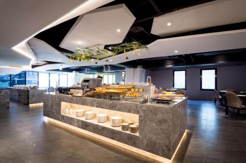 a restaurant with a counter with food on it at Sun Hao Hotel Taichung in Taichung