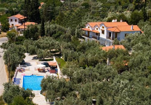 a villa with a swimming pool and a house at Poseidon in Stafylos