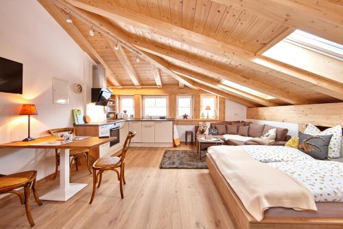 a bedroom with a bed and a living room at Ferienwohnung Ostermair Apartment Gudiberg in Garmisch-Partenkirchen