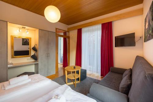 a hotel room with a bed and a couch at Villa Marienhof in Annenheim