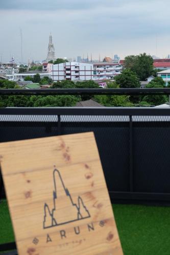 a sign with a drawing of a ship on a balcony at Arun Old Town in Bangkok