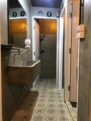 a bathroom with a sink and a tile floor at Arun Old Town in Bangkok