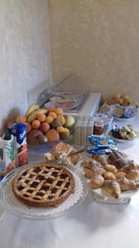 a table with a pie and other foods on it at Camere da Cecè in Tropea