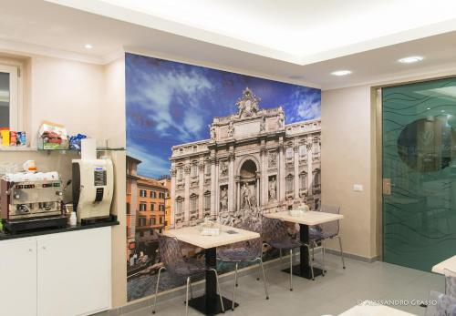 a mural of a building with two tables in a room at Porto Di Claudio in Fiumicino