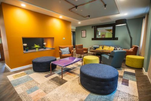 a living room with a couch and chairs at Jonas Hotel in Sheffield