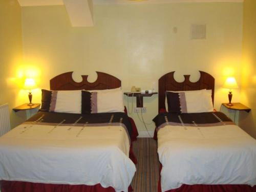 Postel nebo postele na pokoji v ubytování The Anchorage Guest House