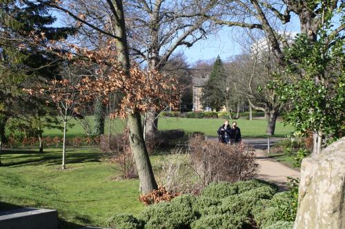 two people walking down a path in a park at Jonas Hotel in Sheffield