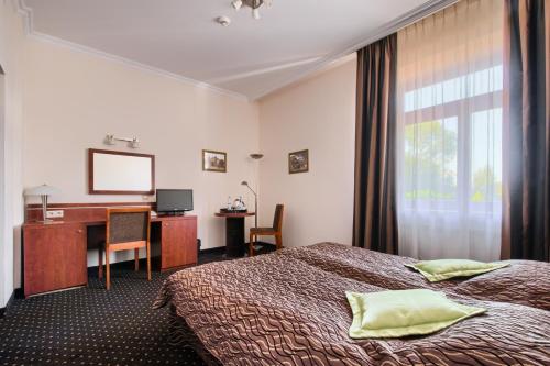 Posteľ alebo postele v izbe v ubytovaní Hotel Sitarska