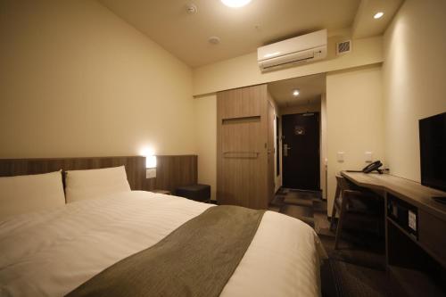 Postel nebo postele na pokoji v ubytování Dormy Inn Korakuen