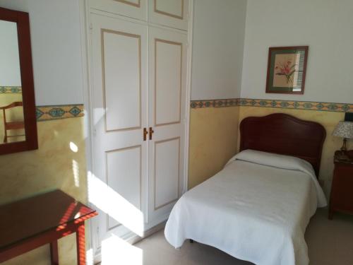 a bedroom with a bed and a white door at Nuevo Hotel in Jerez de la Frontera