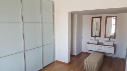 a dressing room with a mirror and a stool at 2 Bedroom Louise in Mutual Heights in Cape Town