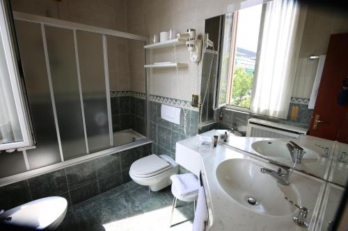 a bathroom with a sink and a toilet at Mokinba Hotels Montebianco in Milan