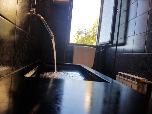 a bathroom with a bath tub with a water fountain at Hotel Mignon in Trieste