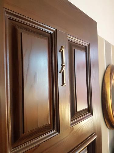 a wooden door with two mirrors on it at Hotel Mignon in Trieste