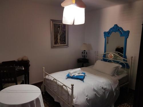 a bedroom with a bed with a blue frame at Hotel Mignon in Trieste