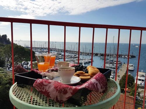 a table on a balcony with a view of the ocean at Hotel Mignon in Trieste
