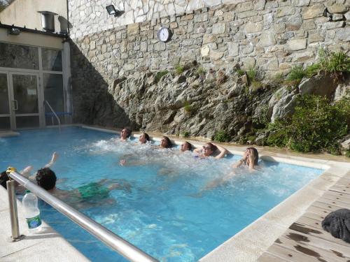 a group of people swimming in a swimming pool at Gîte de Llo - Vue Pyrénées, chambres & PDJ inclus in Llo