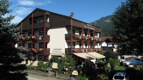 a hotel building with flowers on the front of it at das Christophorus in Söll