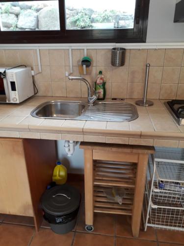 a kitchen counter with a sink and a window at Blue Beach in Famara