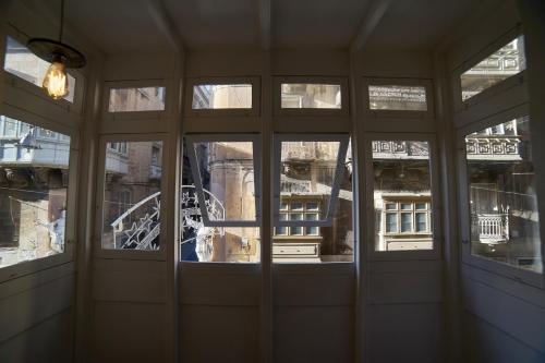 an empty room with a view of a building at Saint Paul Apartment in Valletta