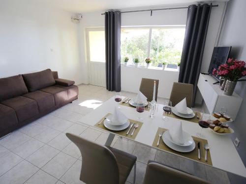 a living room with a table and chairs and a couch at Luxury Holiday Home in Bibinje near Sea in Bibinje