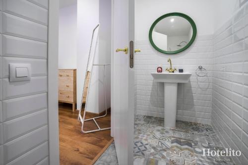 a bathroom with a sink and a mirror at Hotelito Boutique Camp Nou in Hospitalet de Llobregat