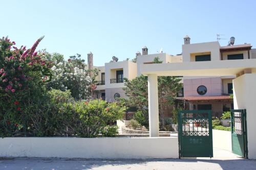 a gate in front of a house with flowers at Athina in Kiotari