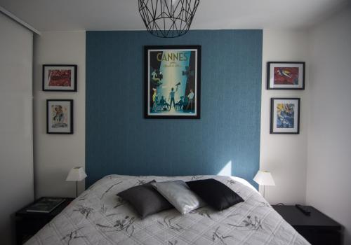 a bedroom with a bed with a poster on the wall at Le Parc Pointe Croisette in Cannes