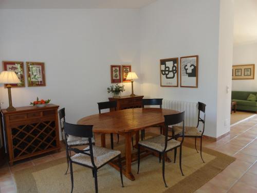 a dining room with a wooden table and chairs at Finca Son Blat in Porto Cristo