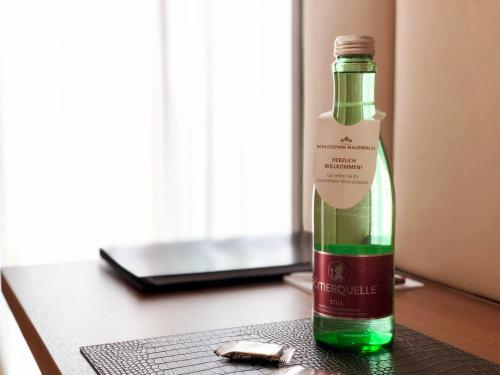 a bottle of wine sitting on top of a table at Schlosspark Mauerbach - Adults only in Mauerbach
