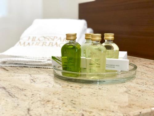 three bottles of alcohol sitting on top of a counter at Schlosspark Mauerbach - Adults only in Mauerbach